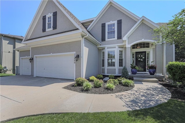 23856 W 124th Ct, Olathe, KS 66061 - traditional-style house featuring an attached garage, driveway, and stucco siding