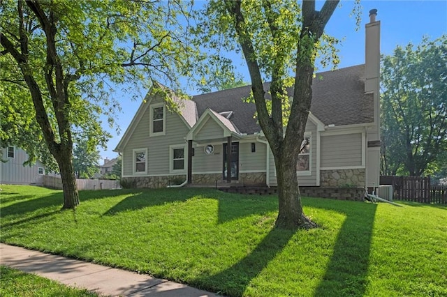 12001 S Hagan St, Olathe, KS 66062 - view of front of house with stone siding, a chimney, and a shingled roof