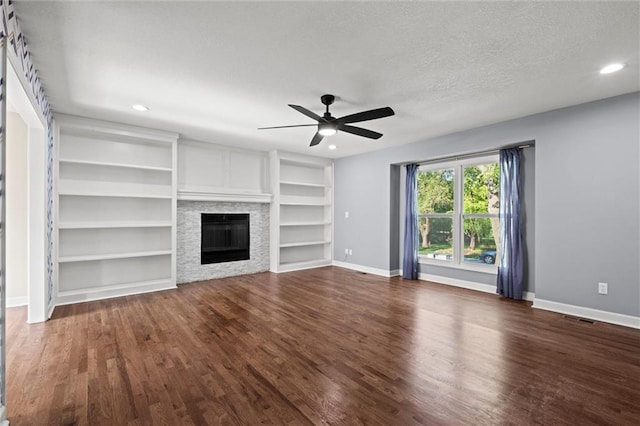 12001 S Hagan St, Olathe, KS 66062 - unfurnished living room featuring a ceiling fan, dark wood-style flooring, baseboards, recessed lighting, and a glass covered fireplace