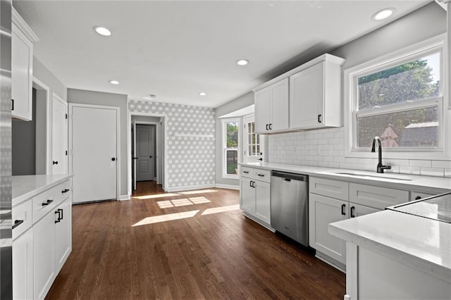 12001 S Hagan St, Olathe, KS 66062 - kitchen featuring dishwasher, a sink, wallpapered walls, light countertops, and white cabinetry