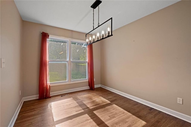 12001 S Hagan St, Olathe, KS 66062 - empty room with wood finished floors, a chandelier, and baseboards