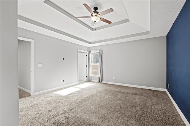 12001 S Hagan St, Olathe, KS 66062 - spare room with a raised ceiling, ceiling fan, and carpet flooring