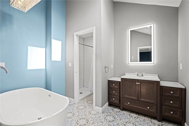 12001 S Hagan St, Olathe, KS 66062 - full bathroom with a shower stall, vanity, a soaking tub, baseboards, and tile patterned floors