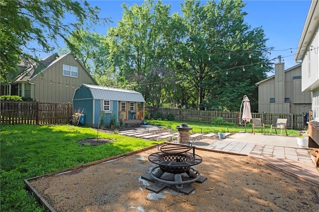 12001 S Hagan St, Olathe, KS 66062 - view of yard featuring a fire pit, a patio, and an outbuilding