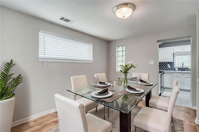6005 NE 50th St, Kansas City, MO 64119 - dining space with light wood-style floors and baseboards