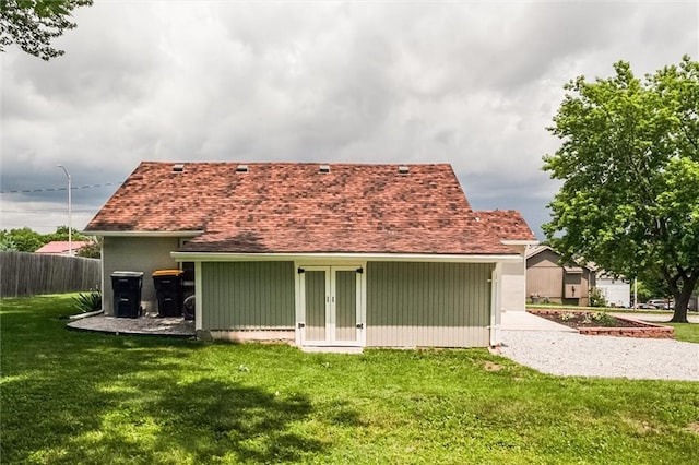 6005 NE 50th St, Kansas City, MO 64119 - back of property with french doors, concrete driveway, and a shingled roof
