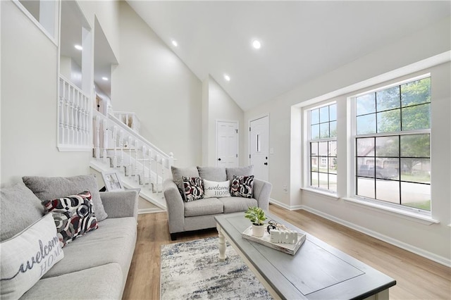 513 Forestglen Ln, Lansing, KS 66043 - living room featuring light wood-type flooring, high vaulted ceiling, stairway, and recessed lighting