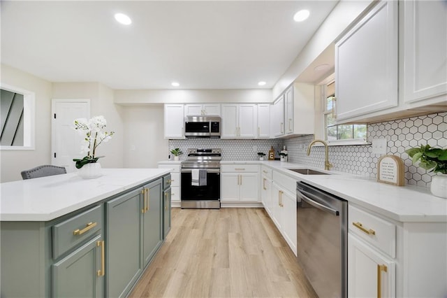 513 Forestglen Ln, Lansing, KS 66043 - kitchen featuring appliances with stainless steel finishes, white cabinetry, light wood finished floors, backsplash, and recessed lighting