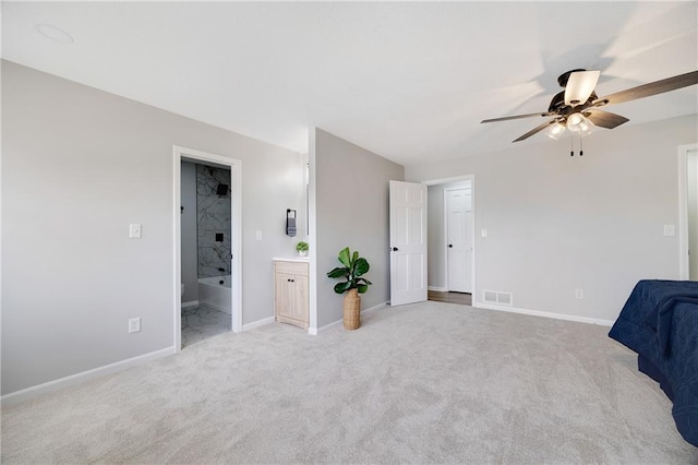 513 Forestglen Ln, Lansing, KS 66043 - unfurnished bedroom featuring light colored carpet, connected bathroom, and ceiling fan