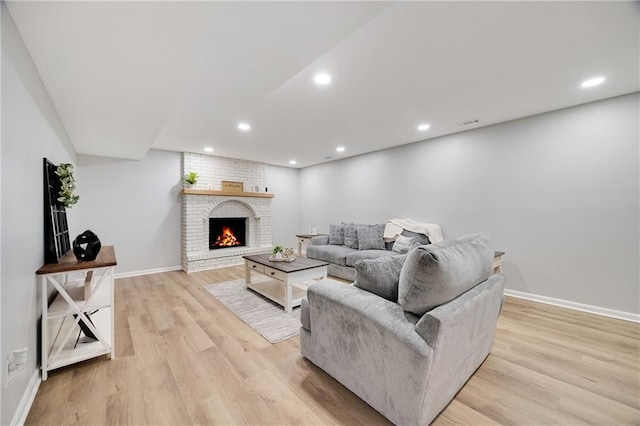 513 Forestglen Ln, Lansing, KS 66043 - living area with light wood-style flooring, a fireplace, and recessed lighting