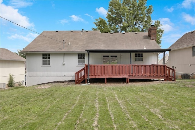513 Forestglen Ln, Lansing, KS 66043 - back of house featuring a yard, a wooden deck, and a chimney