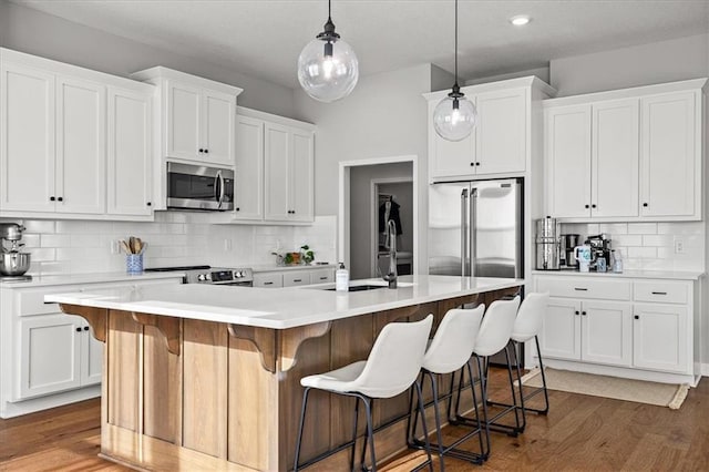 1517 SW Arbor Creek Dr, Lees Summit, MO 64082 - kitchen featuring appliances with stainless steel finishes, a sink, decorative backsplash, white cabinets, and recessed lighting