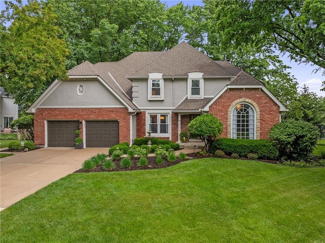 2204 W 123rd Ter, Leawood, KS 66209 - view of front facade with an attached garage, stucco siding, a front yard, driveway, and a shingled roof