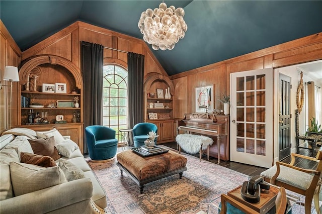 2204 W 123rd Ter, Leawood, KS 66209 - living room featuring wood walls, lofted ceiling, a chandelier, and wood finished floors