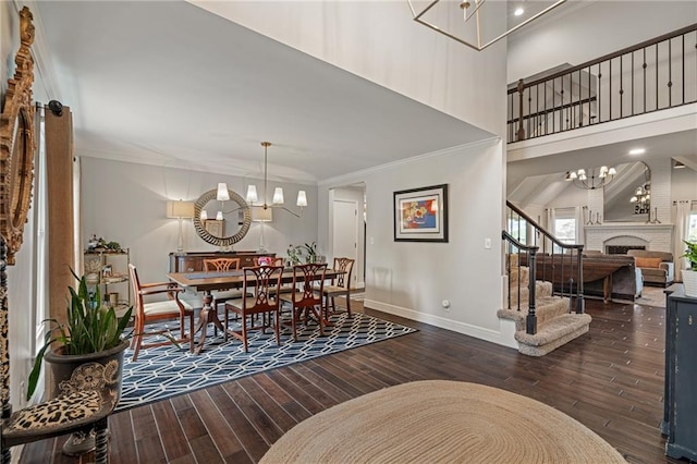 2204 W 123rd Ter, Leawood, KS 66209 - dining area featuring a chandelier, hardwood / wood-style floors, stairway, crown molding, and a fireplace
