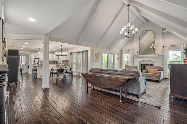 2204 W 123rd Ter, Leawood, KS 66209 - living area with a chandelier, a brick fireplace, dark wood finished floors, beamed ceiling, and high vaulted ceiling