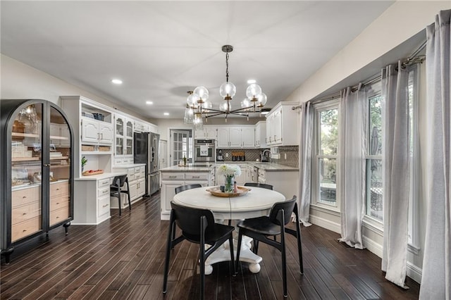 2204 W 123rd Ter, Leawood, KS 66209 - dining area with a chandelier, dark wood-type flooring, recessed lighting, and baseboards