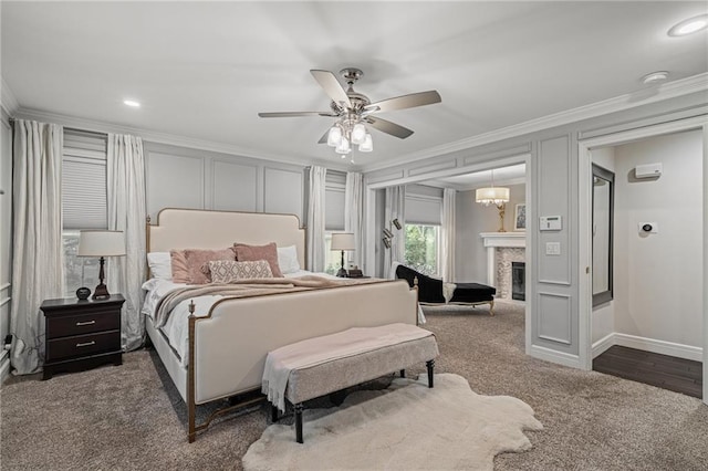 2204 W 123rd Ter, Leawood, KS 66209 - bedroom featuring ornamental molding, carpet, ceiling fan, a glass covered fireplace, and baseboards