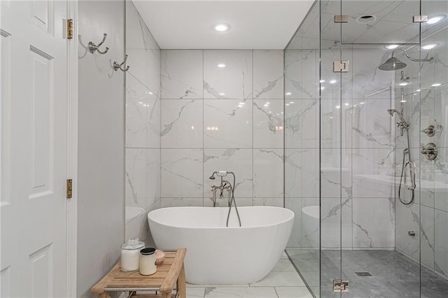 2204 W 123rd Ter, Leawood, KS 66209 - full bathroom featuring tile walls, a soaking tub, a marble finish shower, and marble finish flooring