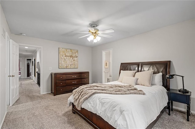 2204 W 123rd Ter, Leawood, KS 66209 - bedroom with light carpet, baseboards, ceiling fan, and ensuite bathroom