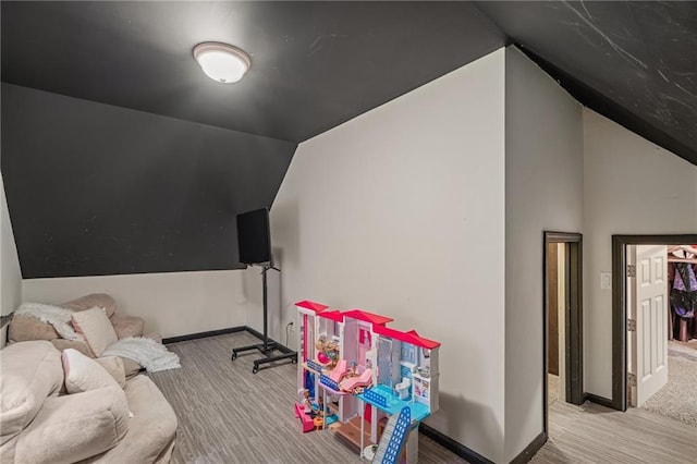 2204 W 123rd Ter, Leawood, KS 66209 - recreation room with vaulted ceiling, baseboards, and wood finished floors