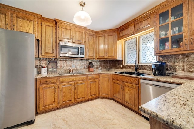 3814 S Outer Belt Rd, Oak Grove, MO 64075 - kitchen with stainless steel appliances, backsplash, brown cabinets, and light stone counters