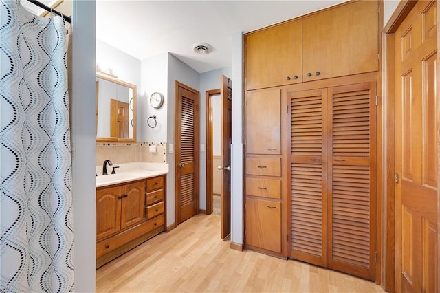 3814 S Outer Belt Rd, Oak Grove, MO 64075 - bathroom with vanity, wood finished floors, a closet, and a shower with curtain