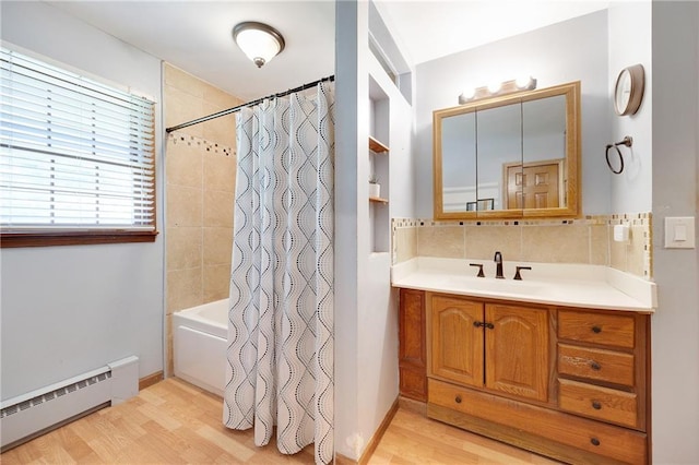 3814 S Outer Belt Rd, Oak Grove, MO 64075 - full bathroom with baseboard heating, vanity, wood finished floors, shower / bath combo, and backsplash