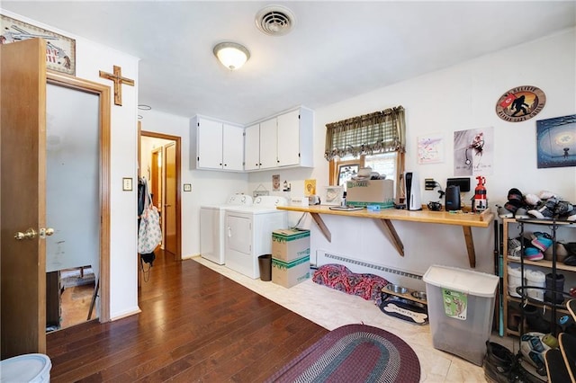3814 S Outer Belt Rd, Oak Grove, MO 64075 - kitchen featuring washing machine and dryer, light countertops, white cabinets, wood finished floors, and a baseboard heating unit