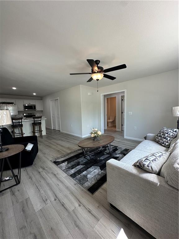 904 N 9th St, Neodesha, KS 66757 - living area featuring light wood-style flooring, ceiling fan, and recessed lighting