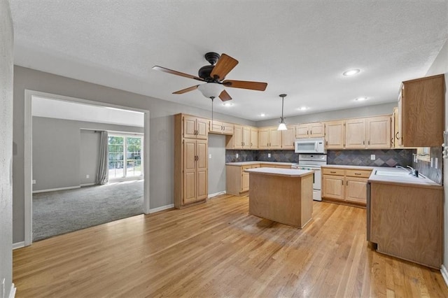 701 NE Hunters Cir, Blue Springs, MO 64014 - kitchen featuring white appliances, a center island, light brown cabinetry, light wood-style floors, and recessed lighting