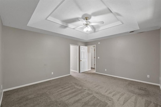 701 NE Hunters Cir, Blue Springs, MO 64014 - carpeted empty room featuring a tray ceiling, ceiling fan, and a textured ceiling