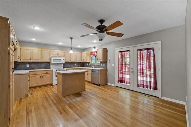 701 NE Hunters Cir, Blue Springs, MO 64014 - kitchen featuring white appliances, light brown cabinets, french doors, a center island, and light countertops