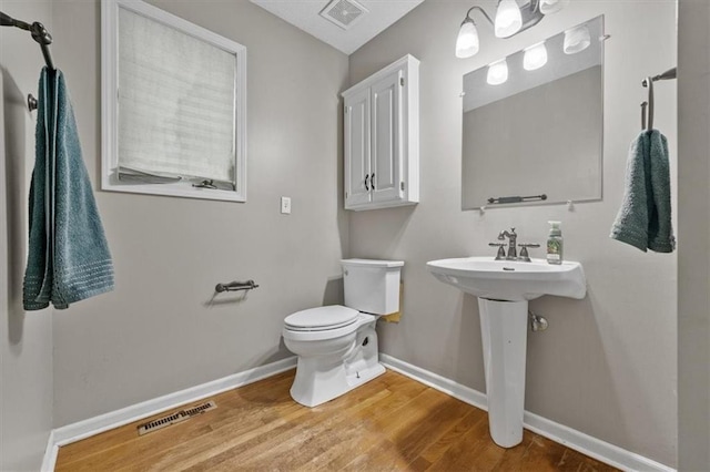 701 NE Hunters Cir, Blue Springs, MO 64014 - half bathroom featuring baseboards and wood finished floors
