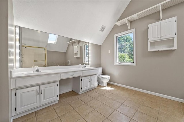 701 NE Hunters Cir, Blue Springs, MO 64014 - bathroom with double vanity, a shower stall, vaulted ceiling, tile patterned floors, and a skylight