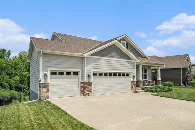 24842 W 144th St, Olathe, KS 66061 - craftsman-style home featuring an attached garage, concrete driveway, covered porch, a shingled roof, and stone siding