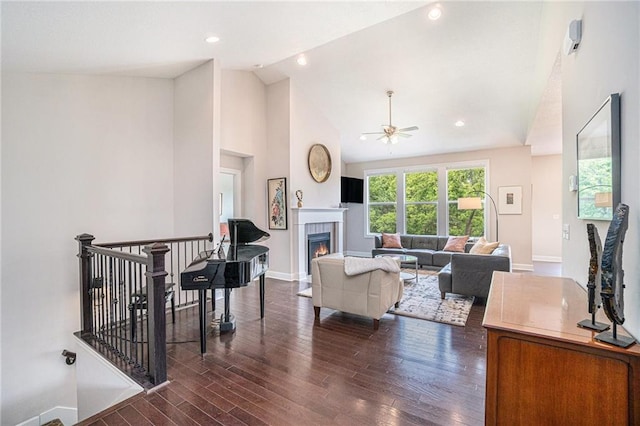 24842 W 144th St, Olathe, KS 66061 - living room featuring ceiling fan, wood finished floors, baseboards, high vaulted ceiling, and a tile fireplace