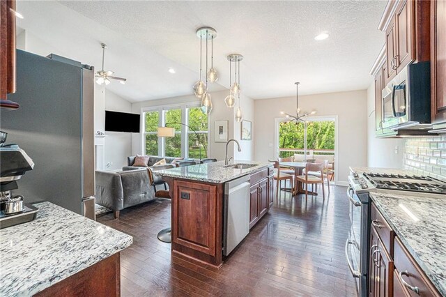 24842 W 144th St, Olathe, KS 66061 - kitchen featuring appliances with stainless steel finishes, a sink, a ceiling fan, open floor plan, and plenty of natural light