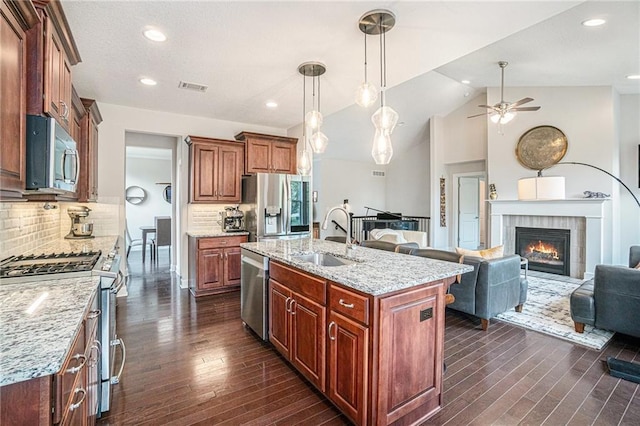 24842 W 144th St, Olathe, KS 66061 - kitchen with appliances with stainless steel finishes, a sink, open floor plan, a ceiling fan, and dark wood-style floors
