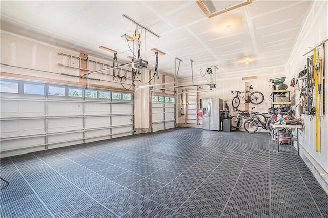 24842 W 144th St, Olathe, KS 66061 - garage featuring stainless steel refrigerator with ice dispenser and a garage door opener