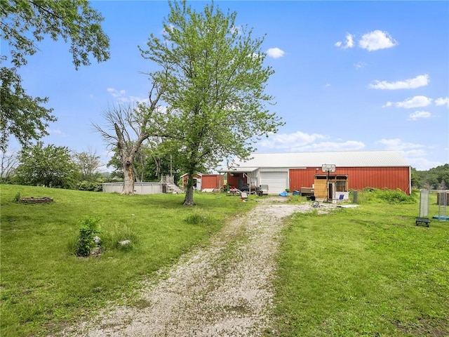 31882 W 180th St, Lawson, MO 64062 - view of green lawn with driveway, an outbuilding, and a pole building