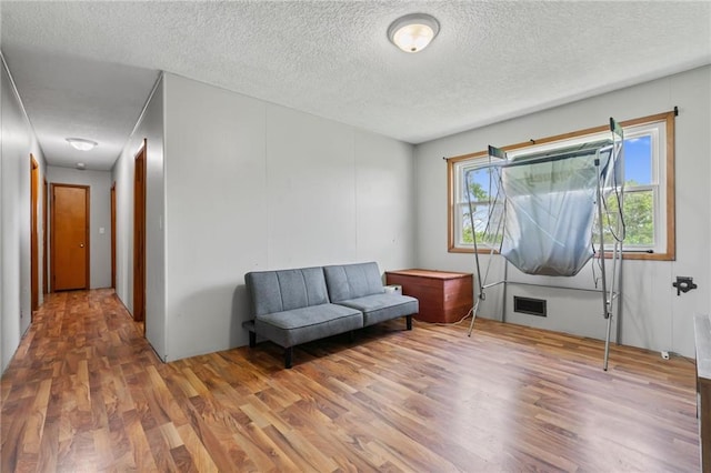 31882 W 180th St, Lawson, MO 64062 - sitting room featuring wood finished floors and a textured ceiling