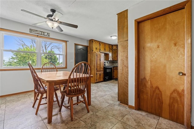 31882 W 180th St, Lawson, MO 64062 - dining room featuring ceiling fan, baseboards, a textured ceiling, and light tile patterned floors