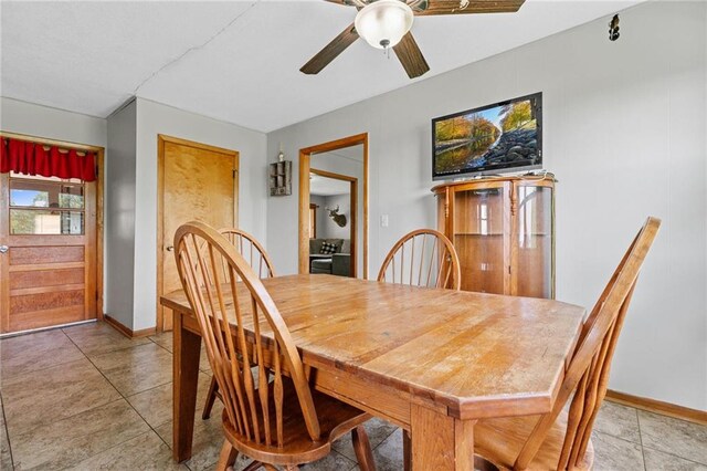 31882 W 180th St, Lawson, MO 64062 - dining area featuring ceiling fan, baseboards, and light tile patterned floors