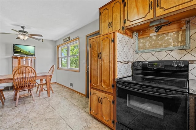 31882 W 180th St, Lawson, MO 64062 - kitchen with black range with electric stovetop, tasteful backsplash, brown cabinetry, a ceiling fan, and light tile patterned floors