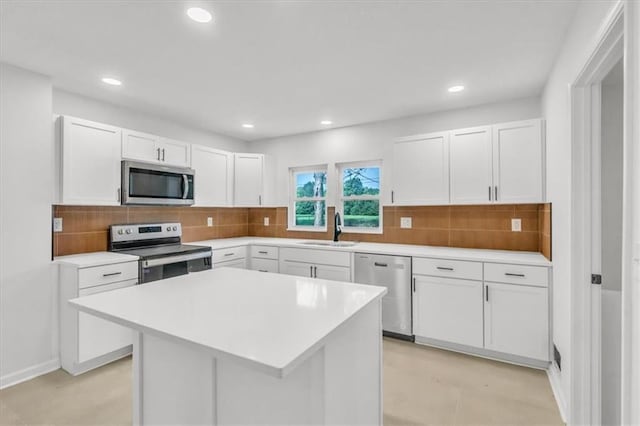 12926 Virginia Ave, Kansas City, MO 64146 - kitchen featuring stainless steel appliances, a sink, white cabinets, light countertops, and recessed lighting