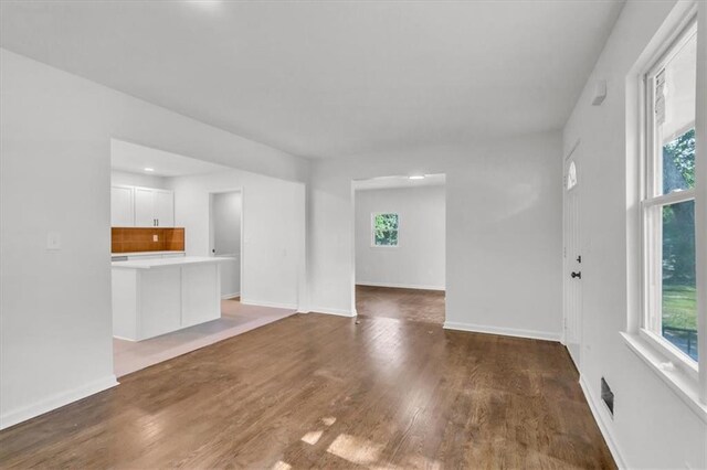 12926 Virginia Ave, Kansas City, MO 64146 - unfurnished living room with wood finished floors and baseboards