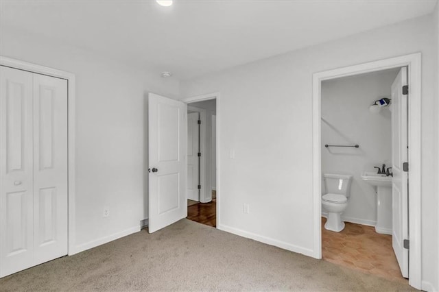 12926 Virginia Ave, Kansas City, MO 64146 - unfurnished bedroom featuring carpet, a closet, baseboards, and connected bathroom