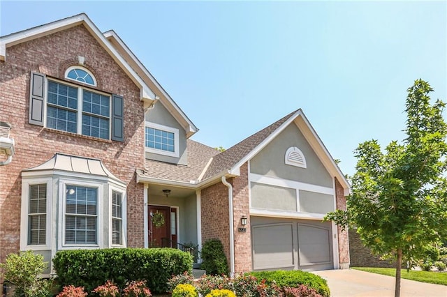 6522 W 133rd Ter, Leawood, KS 66209 - view of front of house with driveway, a garage, roof with shingles, brick siding, and stucco siding