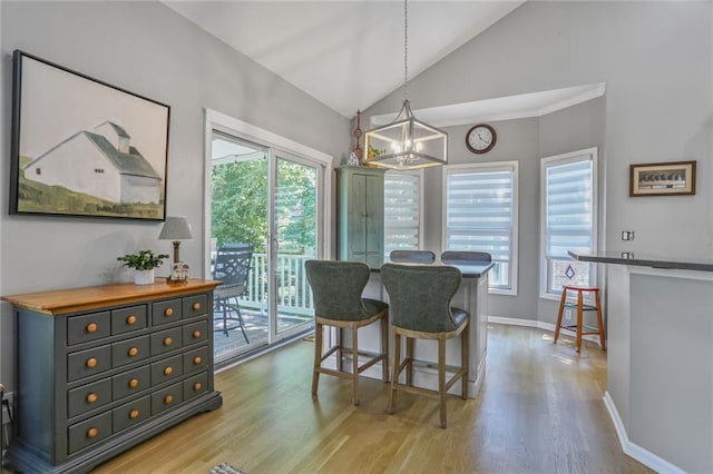 6522 W 133rd Ter, Leawood, KS 66209 - dining area with a chandelier, light wood-style flooring, and high vaulted ceiling